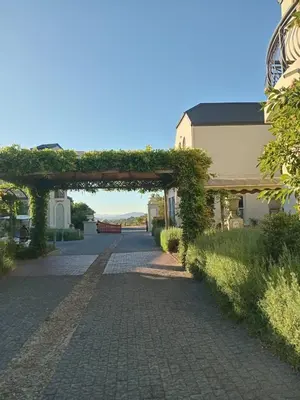 a brick walkway with an arch in a building at L'Ermitage Villa Francois in Franschhoek