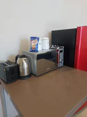 a kitchen counter with a toaster oven and a microwave at Nemesia Suites in Cape Town