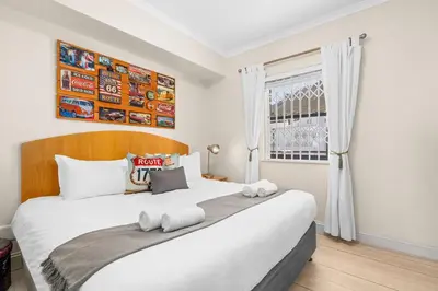 a bedroom with a large white bed in a room at Gordons Village View in Cape Town