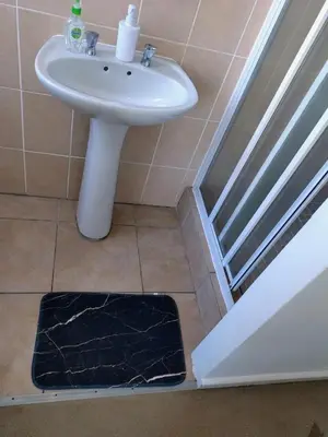 a bathroom with a sink next to a door at Polaris House in Cape Town