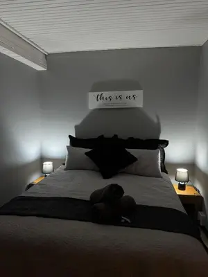 a bedroom with a bed with a sign that reads this is us at Worcester Cozy Stay - Apto 1 in Worcester