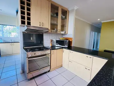 a kitchen with a stove and a microwave at 4 Bedroom Bliss in Cape Town