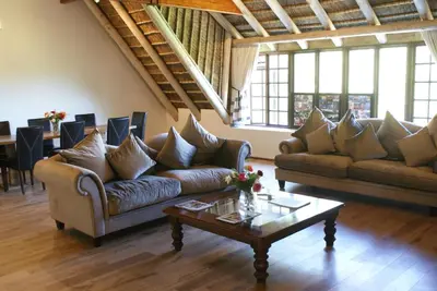 a living room with couches and a coffee table at Wedgeview Country House & Spa in Stellenbosch