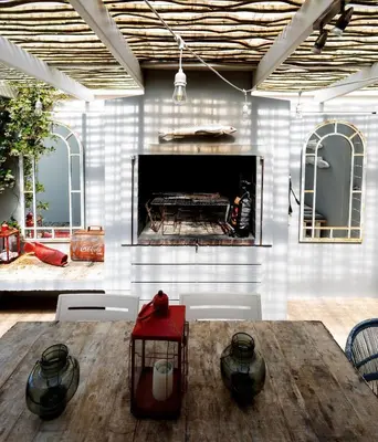 a living room with a table and a fireplace at Silencio in Hermanus