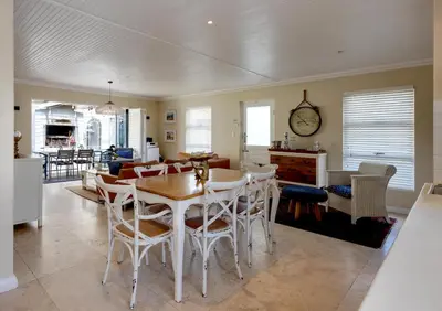 a kitchen and dining room with a table and chairs at Silencio in Hermanus