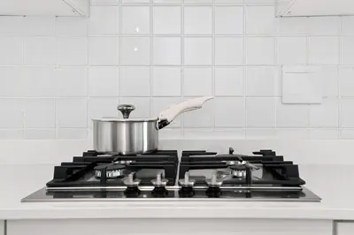 a pot on top of a stove in a kitchen at Modern Luxury 2BR Island Club Century City in Cape Town