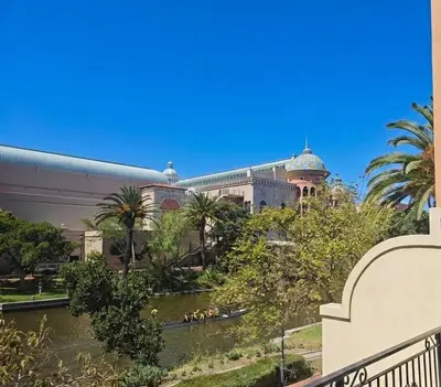 a large building with a river in front of it at Modern Luxury 2BR Island Club Century City in Cape Town