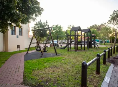 a park with a playground with a swing set at Modern Luxury 2BR Island Club Century City in Cape Town