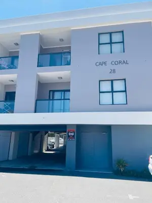 a blue building with a car rental sign on it at Cape Coral in Cape Town
