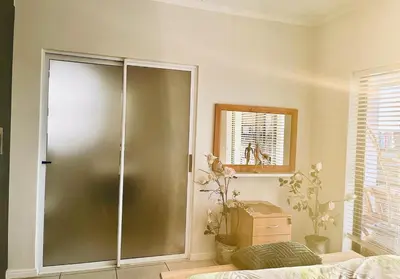 a bathroom with a shower with a glass door at Cape Town Apartment with Table Mountain View in Cape Town