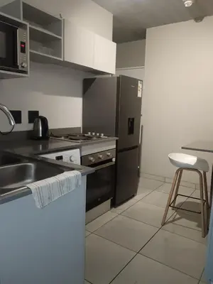 a kitchen with a sink and a stove top oven at Belhar Lofts in Belhar