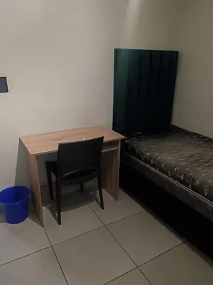 a desk and a chair next to a bed at Belhar Lofts in Belhar