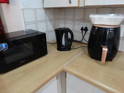 a microwave sitting on a counter next to a coffee maker at African Oasis Cameroon in Somerset West