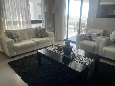 a living room with a couch and a coffee table at Aquarius Luxury Suites 406 in Cape Town