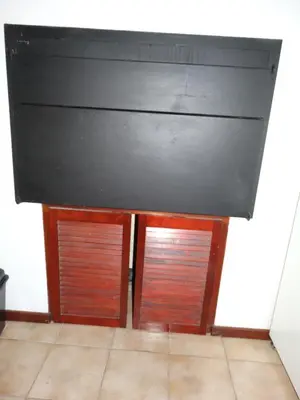 a kitchen with two wooden cabinets and a counter top at African Oasis Zambia in Somerset West
