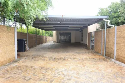 an empty parking lot of a building with a garage at African Oasis Zambia in Somerset West