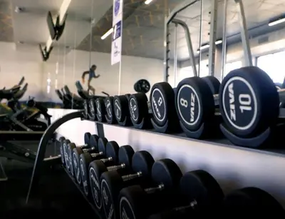a row of dumbbells in a gym at Cosy Apartment at Sitari Country Estate - Somerset West in Croydon