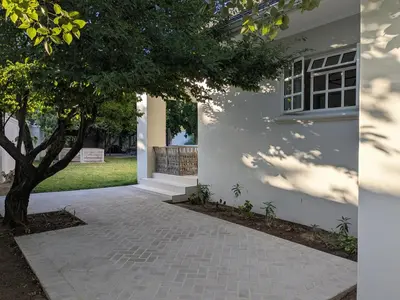 a white house with a tree and a walkway at Fifty9 in Somerset West