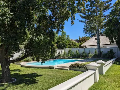 a swimming pool in the yard of a house at Fifty9 in Somerset West