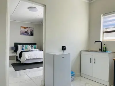 a bedroom with a bed and a mirror at Maita Corner in Monte Vista