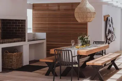 a dining room with a table and chairs and a fireplace at Endless summer in Hermanus