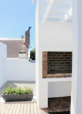 a view from the outside of a house with a brick fireplace at Endless summer in Hermanus