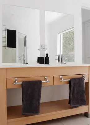 a bathroom with two towels hanging under a sink at Endless summer in Hermanus