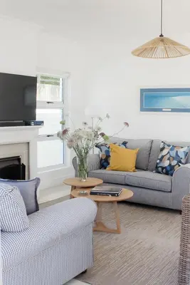 a living room with two couches and a table at Endless summer in Hermanus