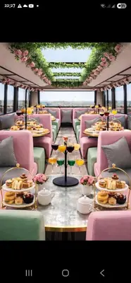 a dining car of a train with plates of food at Atlantic Lorea hight Tea in Cape Town