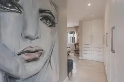 a painting of a woman on a wall in a room at Avemore Lagratitude no6 - with full backup power in Stellenbosch