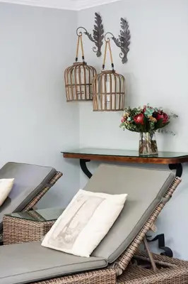a table and chairs with baskets on the wall at Avemore Lagratitude no6 - with full backup power in Stellenbosch