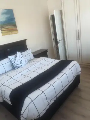 a bedroom with a large white bed in a room at Sleep easy at Peperboom in Kuilsrivier
