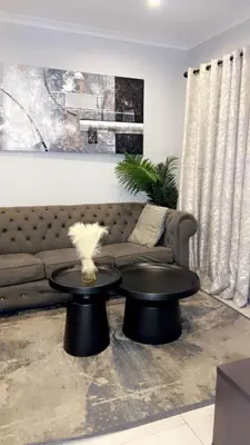 a living room with a couch and a table at Smart and elegant space in Cape Town