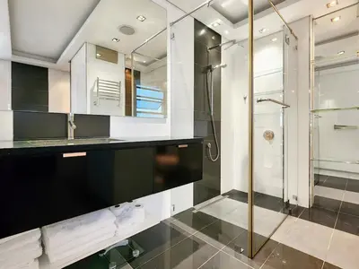 a bathroom with a glass shower and a sink at Bird's View in Cape Town