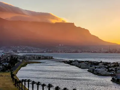 a view of the ocean with a mountain in the background at Bird's View in Cape Town