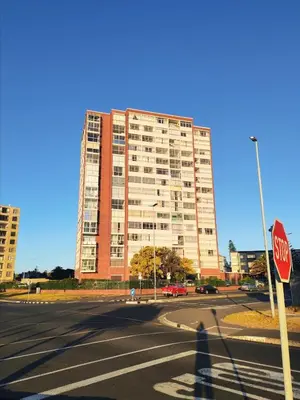 a stop sign in front of a large building at Bird's View in Cape Town