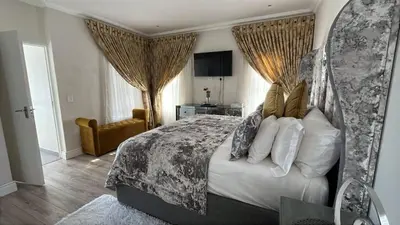 a bedroom with a king sized bed with a canopy at KwaNolz in Cape Town