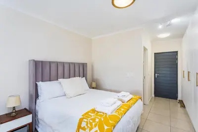 a bedroom with a bed with two towels on it at Waterstone A202 by CTHA in Cape Town
