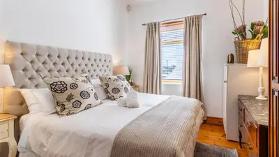 a bedroom with a large white bed with pillows at 59 Marine Hermanus in Hermanus
