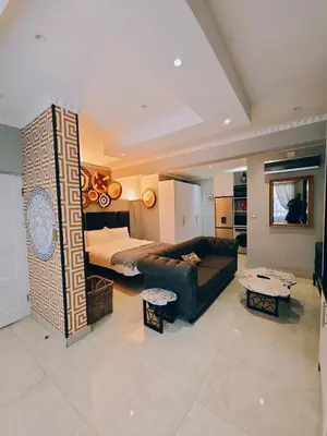 a living room with a couch and a bed at Beachwalk luxury one bedroom apartments in Cape Town