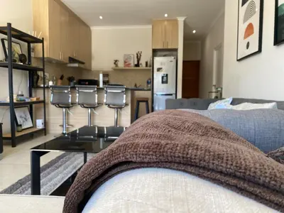 a living room with a couch and a table at Elegant, Relaxing Gateway House in Cape Town in Cape Town