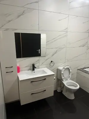 a white bathroom with a sink and a toilet at Bell rose oaks guest house in Blomtuin