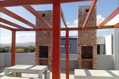 a view from the roof of a house with a table at Her Sanctuary in Cape Town