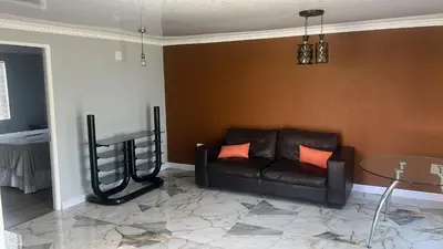a living room with a couch and a table at Oryx guest house in Oakdale