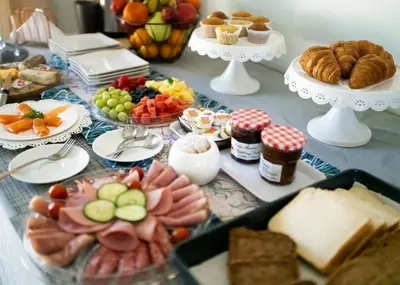 a table topped with lots of different types of food at De Wingerd Wijnland Lodge in Paarl