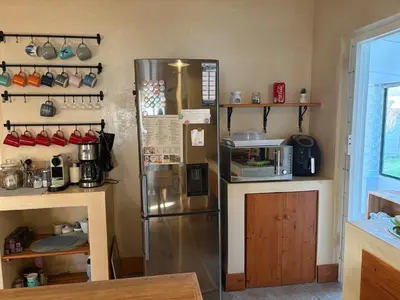 a kitchen with a stainless steel refrigerator at Peaceful coastal holiday home in Hermanus