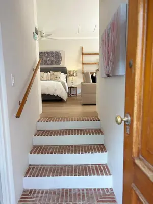 a hallway with stairs leading to a bedroom at Protea Cottage Cozy & Private Studio in Claremont in Cape Town