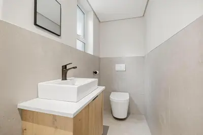 a bathroom with a sink and a toilet at Cape Signature Villa in Cape Town