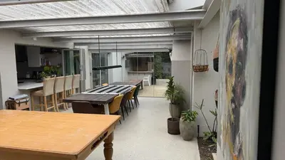 a kitchen and dining room with a table and chairs at Large and spacious family home is leafy suburb in Stellenbosch