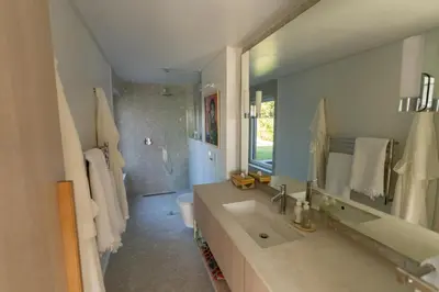 a bathroom with a sink and a toilet and a mirror at Pringle Bay Beach Cottage in Pringle Bay